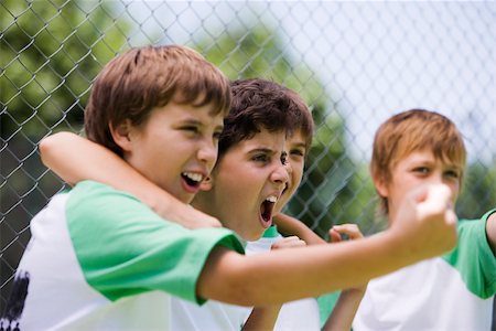 Young teammates cheering from sidelines Stock Photo - Premium Royalty-Free, Code: 632-03500652