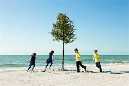 simsearch:632-03500607,k - Children playing chase around tree growing on beach Stock Photo - Premium Royalty-Free, Code: 632-03500781