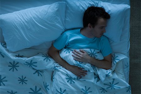 eiderdown - Man lying awake in bed contemplatively looking away Stock Photo - Premium Royalty-Free, Code: 632-03500821