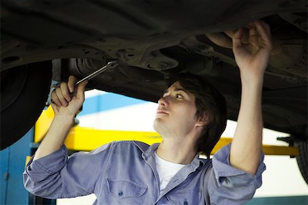 simsearch:632-03083042,k - Mechanic working on underside of car elevated on hydraulic lift Stock Photo - Premium Royalty-Free, Code: 632-03500894