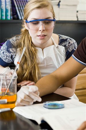 High school student conducting experiment in chemistry class Stock Photo - Premium Royalty-Free, Code: 632-03516594