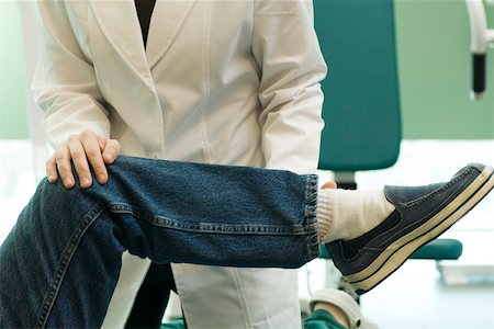 simsearch:632-01613036,k - Doctor examining patient's leg and knee joint flexibility Stock Photo - Premium Royalty-Free, Code: 632-03516746