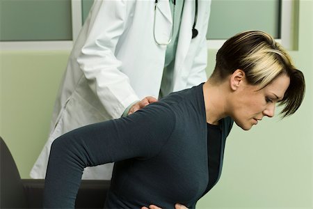 stomachache - Doctor assisting patient experiencing severe abdominal pain Stock Photo - Premium Royalty-Free, Code: 632-03516763