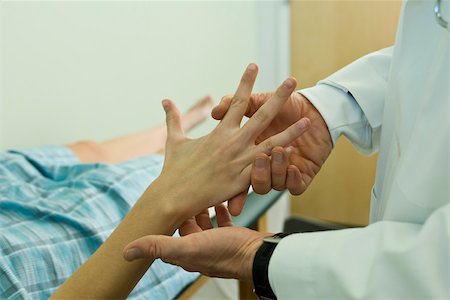 simsearch:694-03331631,k - Doctor examining patient's hand Stock Photo - Premium Royalty-Free, Code: 632-03516770