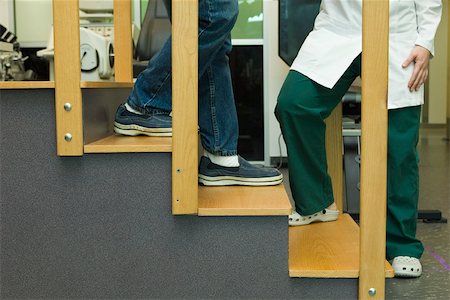 practicing (non sports) - Patient practicing going down steps as part of rehabilitation exercise Stock Photo - Premium Royalty-Free, Code: 632-03516795