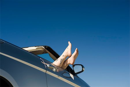 sticking out - Relaxing in parked convertible, feet resting on door Stock Photo - Premium Royalty-Free, Code: 632-03516839