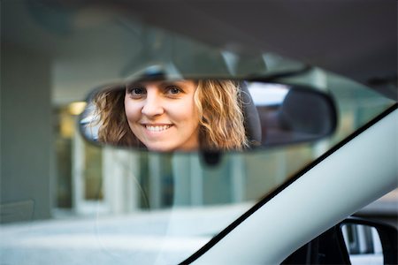 personal perspective - Woman's face reflected in rearview mirror Stock Photo - Premium Royalty-Free, Code: 632-03516859