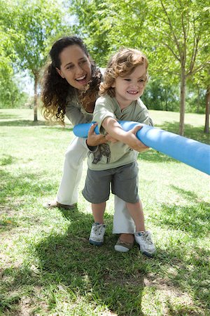 Mother and young son playing tug-of-war Stock Photo - Premium Royalty-Free, Code: 632-03516990