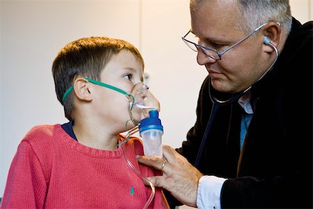 Boy receiving oxygen treatment Stock Photo - Premium Royalty-Free, Code: 632-03629712