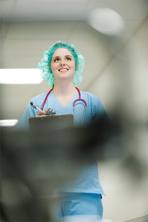 simsearch:632-05401320,k - Nurse wearing surgical cap, low angle view Stock Photo - Premium Royalty-Free, Code: 632-03629911