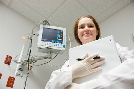 Nurse with binder, low angle view Stock Photo - Premium Royalty-Free, Code: 632-03629924