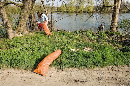 Volunteers picking up trash outdoors Stock Photo - Premium Royalty-Free, Code: 632-03651650