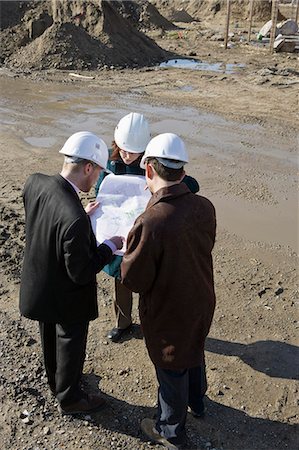 Architect meeting with engineers at construction site discussing blueprints Stock Photo - Premium Royalty-Free, Code: 632-03652167