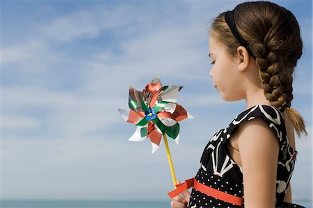 Little girl blowing pinwheel Stock Photo - Premium Royalty-Free, Code: 632-03652288