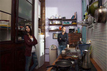 simsearch:632-01148228,k - Couple looking away from each other in kitchen with arms folded Stock Photo - Premium Royalty-Free, Code: 632-03754310