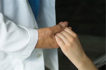 sympathy - Doctor holding patient's hand, cropped Stock Photo - Premium Royalty-Free, Code: 632-03754339