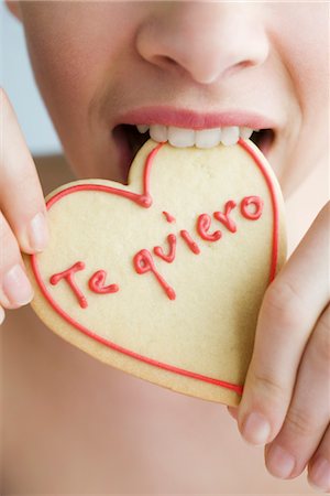 spanish ethnicity (female) - Eating heart-shaped cookie Stock Photo - Premium Royalty-Free, Code: 632-03754644