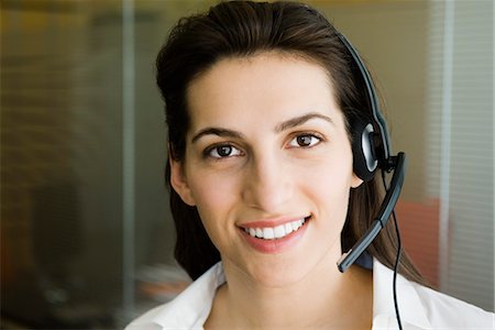 Woman wearing telephone headset, portrait Stock Photo - Premium Royalty-Free, Code: 632-03779536