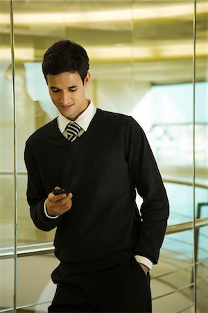 simsearch:632-05400935,k - Businessman text messaging with cell phone Stock Photo - Premium Royalty-Free, Code: 632-03779782