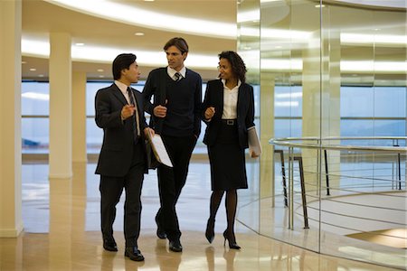 Business executives walking and talking together in building Stock Photo - Premium Royalty-Free, Code: 632-03779809