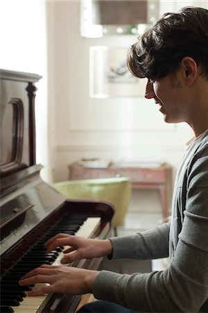 piano practice - Young man playing piano Stock Photo - Premium Royalty-Free, Code: 632-03847614