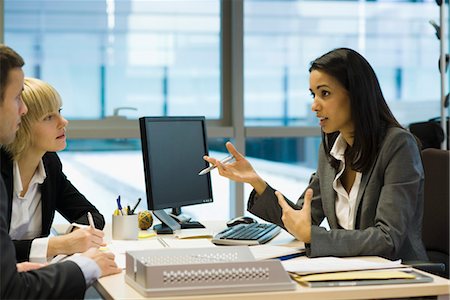 person desktop computer office - Female executive talking to colleagues Stock Photo - Premium Royalty-Free, Code: 632-03848075