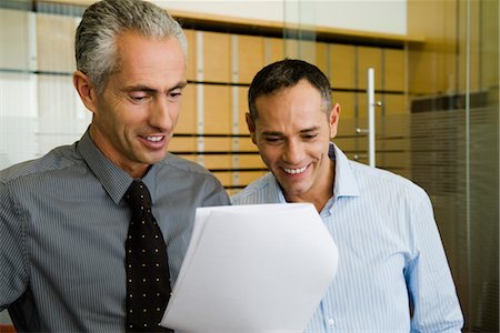 simsearch:632-05400935,k - Businessmen looking at document together Stock Photo - Premium Royalty-Free, Code: 632-03848081