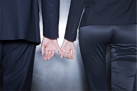 Professionals holding hands, cropped Stock Photo - Premium Royalty-Free, Code: 632-03848125