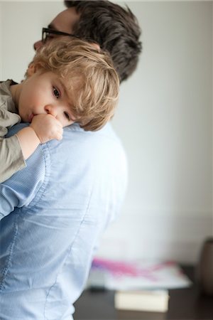Toddler boy resting head on father's shoudler Stock Photo - Premium Royalty-Free, Code: 632-03848422