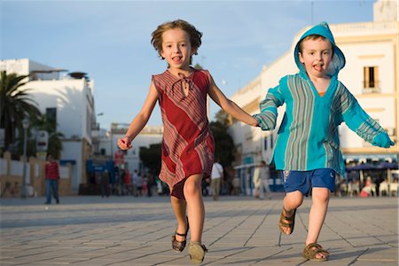 Young siblings running hand in hand Stock Photo - Premium Royalty-Free, Code: 632-03897980