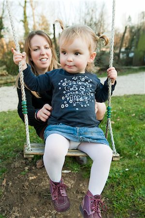 swing (apparatus) - Mother pushing toddler girl on swing Stock Photo - Premium Royalty-Free, Code: 632-03898175