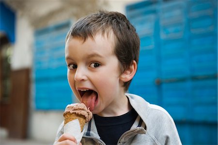 enjoy ice cream - Boy licking ice cream cone, portrait Stock Photo - Premium Royalty-Free, Code: 632-03898201
