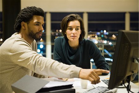 Colleagues working on project together in office at night Stock Photo - Premium Royalty-Free, Code: 632-03898343