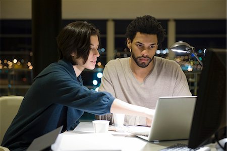 Colleagues working on project together in office at night Stock Photo - Premium Royalty-Free, Code: 632-03898390