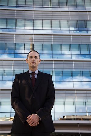 simsearch:632-05604036,k - Executive standing in front building, portrait Stock Photo - Premium Royalty-Free, Code: 632-03898459