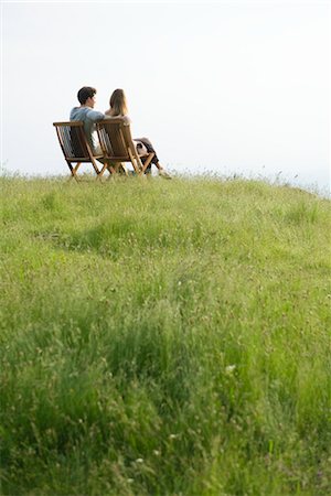 person sitting on a lawn chair - Couple sitting on chairs on top of hill looking at view Stock Photo - Premium Royalty-Free, Code: 633-05401437