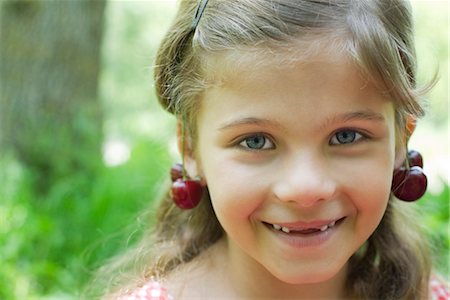 ear human - Girl with cherries dangling from her ears, portrait Stock Photo - Premium Royalty-Free, Code: 633-05401773