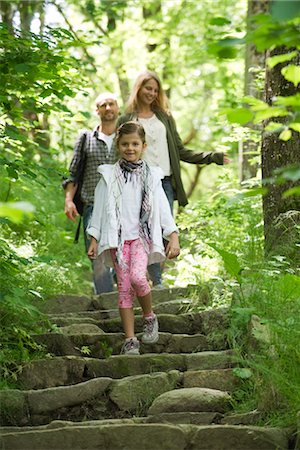 Family walking down steps in woods Stock Photo - Premium Royalty-Free, Code: 633-05401933