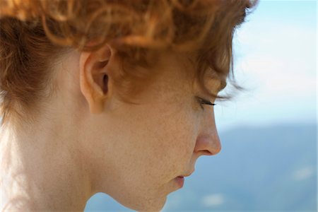 Redheaded woman with hair up, side view Stock Photo - Premium Royalty-Free, Code: 633-05402125