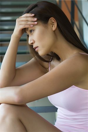 Young woman holding head Stock Photo - Premium Royalty-Free, Code: 633-05402210