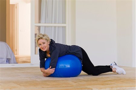 Mature woman lying on stomach on fitness ball Stock Photo - Premium Royalty-Free, Code: 633-06322271