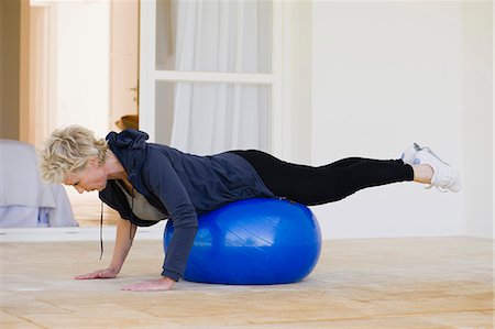 Mature woman doing pilates exercise on fitness ball Stock Photo - Premium Royalty-Free, Code: 633-06322442