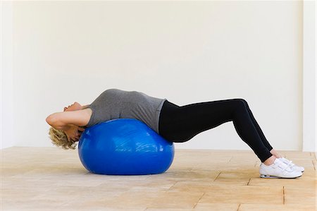 Woman lying on fitness ball Stock Photo - Premium Royalty-Free, Code: 633-06322537
