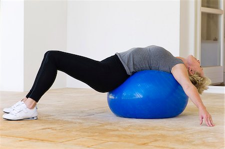 Mature woman lying on fitness ball Stock Photo - Premium Royalty-Free, Code: 633-06322595