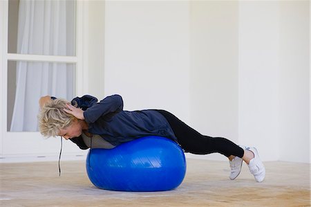 Mature woman doing pilates exercise on fitness ball Stock Photo - Premium Royalty-Free, Code: 633-06322663