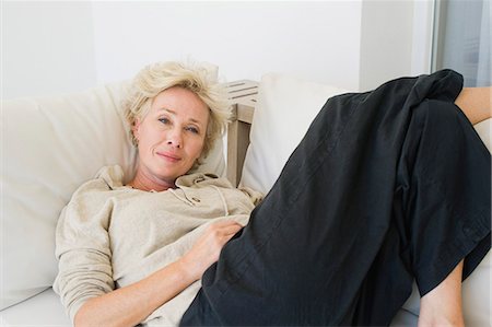 Mature woman reclining on sofa Stock Photo - Premium Royalty-Free, Code: 633-06354936