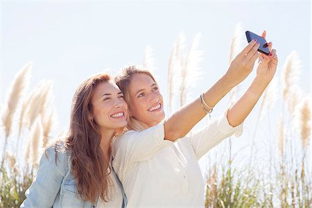 simsearch:632-07674444,k - Friends pausing for selfie during road trip Stock Photo - Premium Royalty-Free, Code: 633-08150738