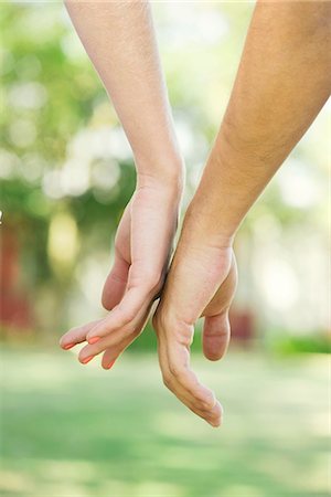 Couple touching hands outdoors, cropped rear view Stock Photo - Premium Royalty-Free, Code: 633-08150913