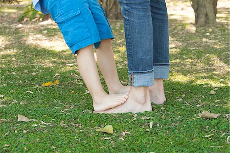 Little boy standing barefoot on father's feet, cropped Stock Photo - Premium Royalty-Free, Code: 633-08151098