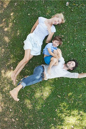 simsearch:673-06964589,k - Young family with boy lying together on grass Stock Photo - Premium Royalty-Free, Code: 633-08151100